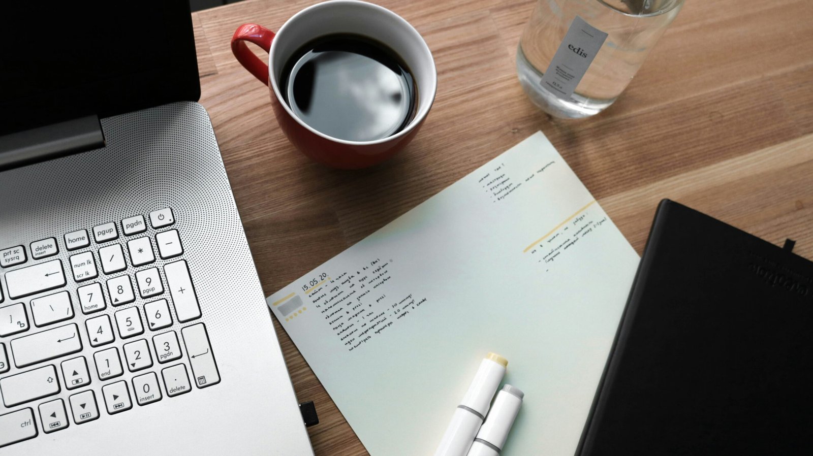 white printer paper beside white ceramic mug on brown wooden table